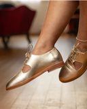 The Ava derby in Platinum, worn on a wood floor