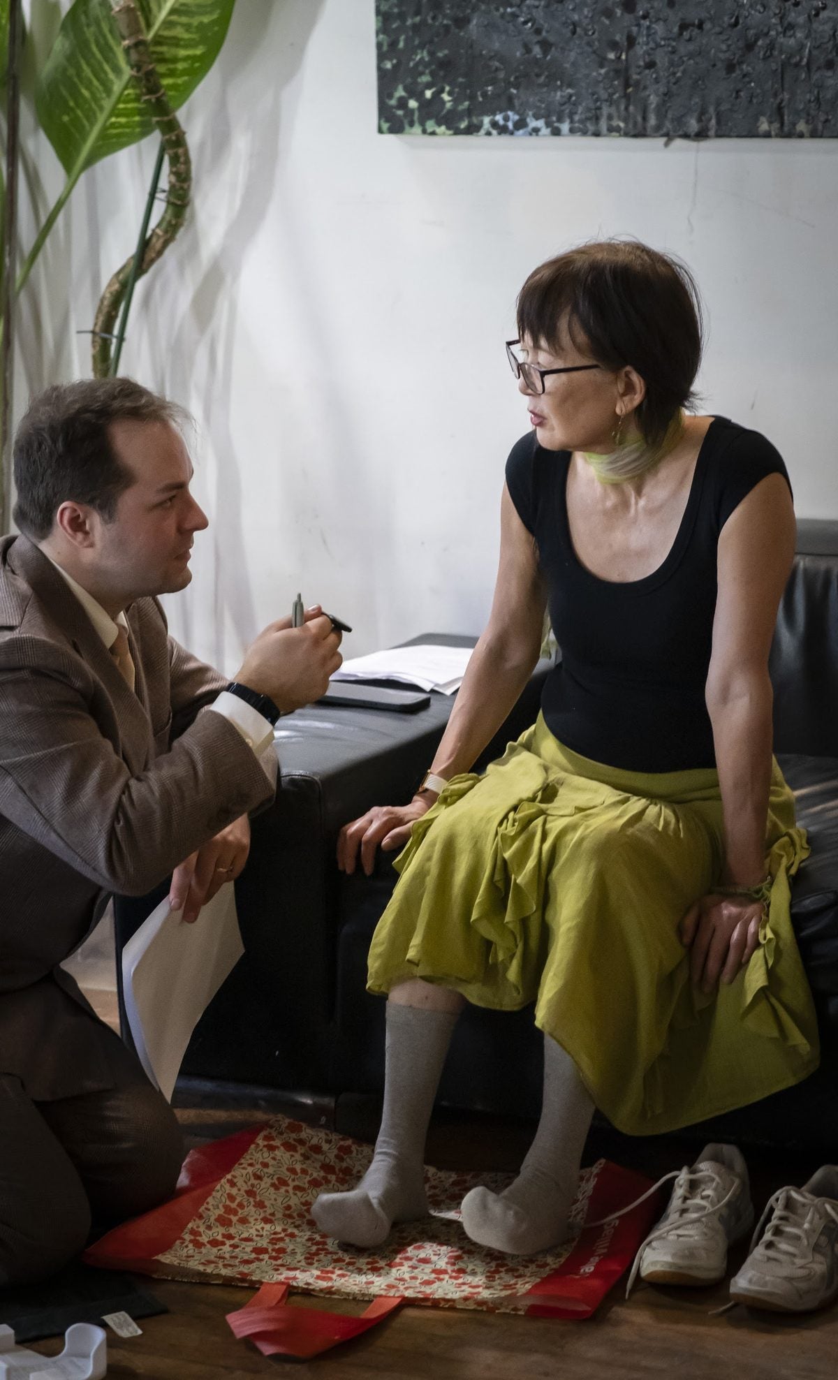 A marleys fitting: kneeling beside a dancer to check her fit