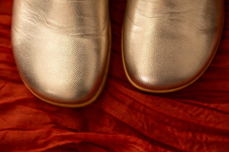 A gold pair of marleys on red velvet